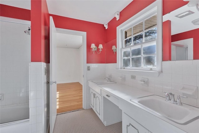 bathroom with vanity, tile patterned floors, and tile walls