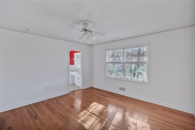 spare room featuring light wood-type flooring and ceiling fan