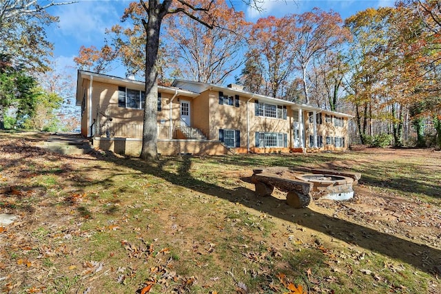 rear view of property with a yard