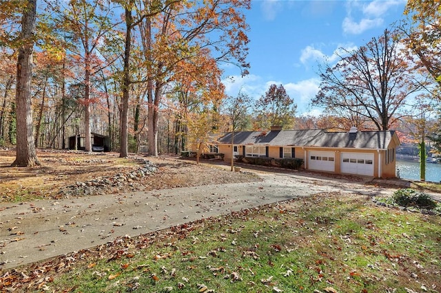 view of front of house featuring a garage and a water view