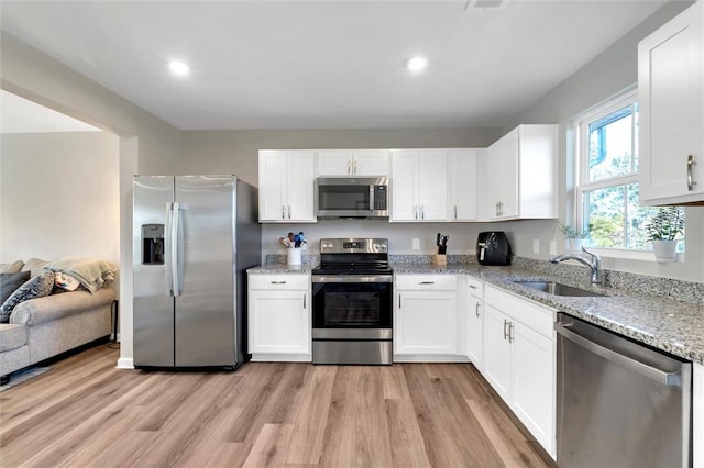 120 Sligh Way, Easley, SC 29642 - kitchen with stainless steel appliances, light stone countertops, light wood finished floors, white cabinetry, and recessed lighting