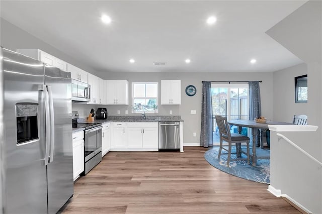 120 Sligh Way, Easley, SC 29642 - kitchen featuring appliances with stainless steel finishes, white cabinetry, healthy amount of natural light, light wood-style floors, and recessed lighting