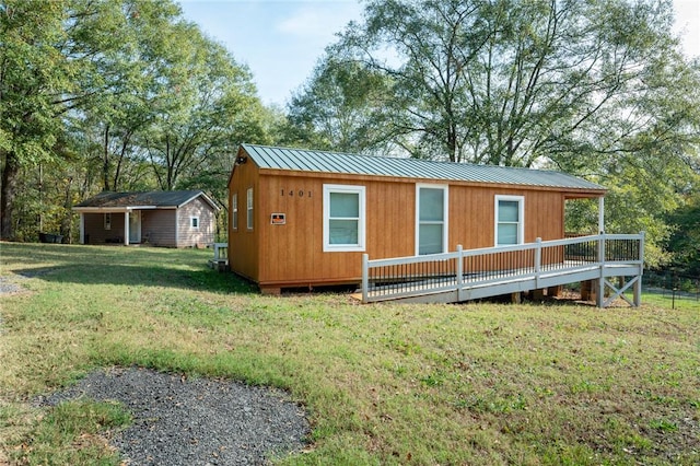 exterior space featuring a wooden deck and a lawn