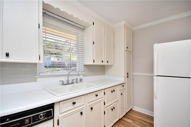 kitchen featuring white cabinetry, dishwasher, sink, and white fridge