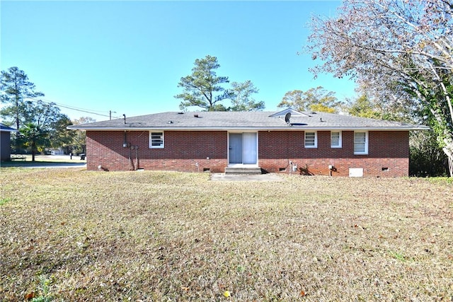 back of property with a lawn