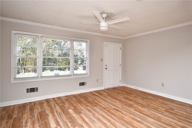 spare room with light hardwood / wood-style flooring, ceiling fan, and crown molding