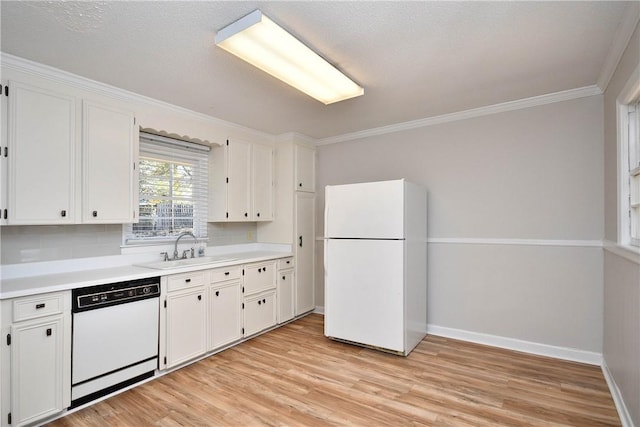 kitchen with white appliances, backsplash, sink, light hardwood / wood-style flooring, and white cabinetry