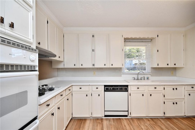 kitchen featuring white appliances, light hardwood / wood-style flooring, white cabinetry, and sink