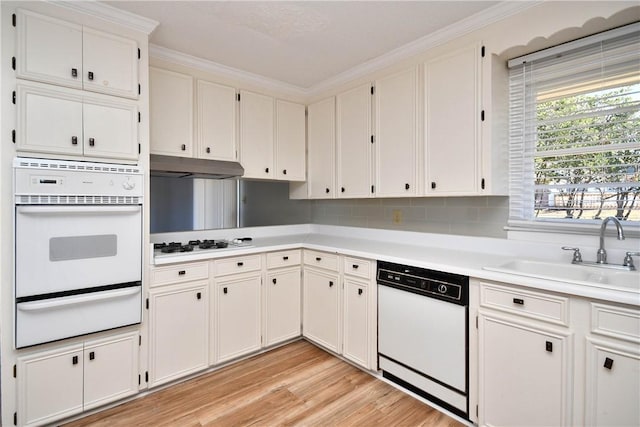 kitchen featuring sink, white cabinets, white appliances, and ornamental molding