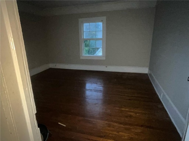 spare room featuring dark hardwood / wood-style flooring