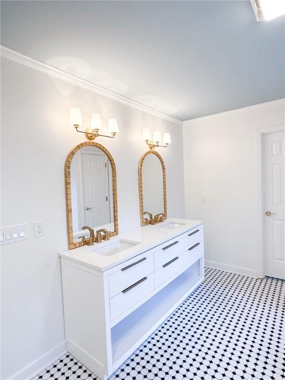 bathroom with tile patterned flooring, vanity, and crown molding