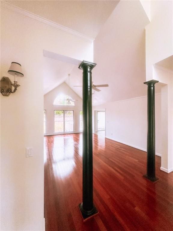 unfurnished living room with ceiling fan, dark hardwood / wood-style floors, and vaulted ceiling