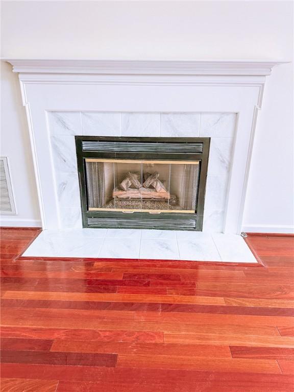 details with a fireplace and wood-type flooring