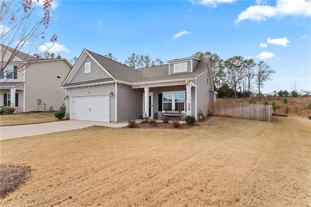 view of front of house featuring a garage, covered porch, and a front yard