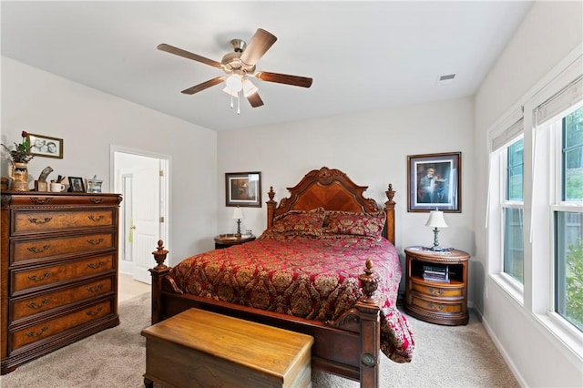 carpeted bedroom featuring ceiling fan and multiple windows