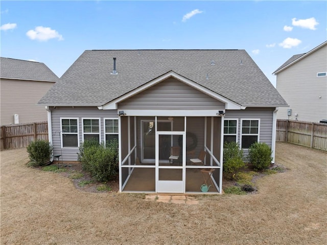 back of house with a yard and a sunroom