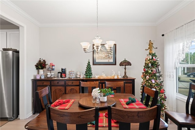 dining room with a chandelier and ornamental molding