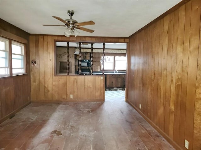 409 Simpson St, Westminster, SC 29693 - unfurnished living room with wood walls and a ceiling fan