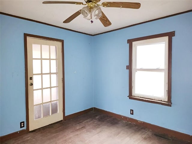 unfurnished room featuring ceiling fan, a healthy amount of sunlight, and ornamental molding