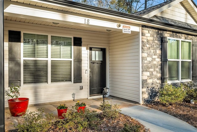 view of exterior entry featuring a porch