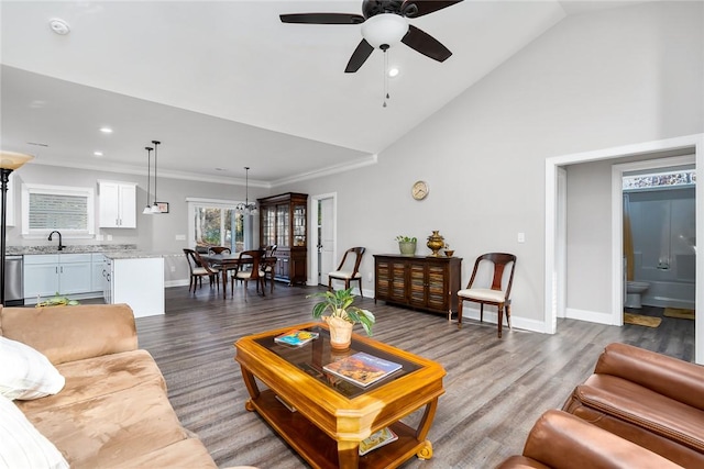 living room featuring dark hardwood / wood-style floors, ceiling fan, ornamental molding, and sink