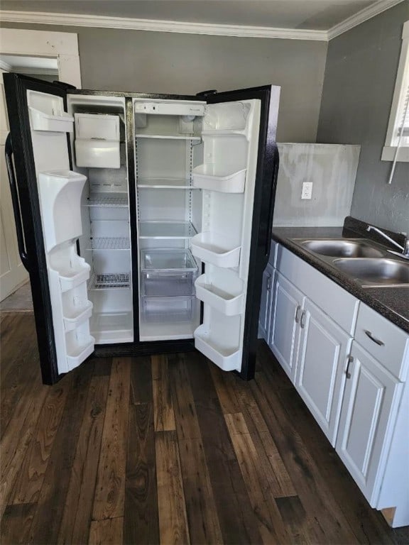 kitchen with white cabinetry, sink, dark wood-type flooring, and ornamental molding