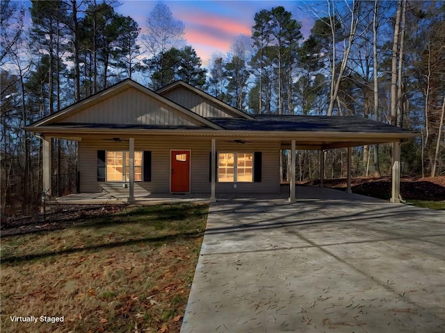 view of front facade featuring covered porch and a carport