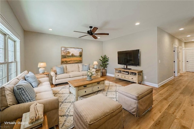 living room with ceiling fan and light wood-type flooring