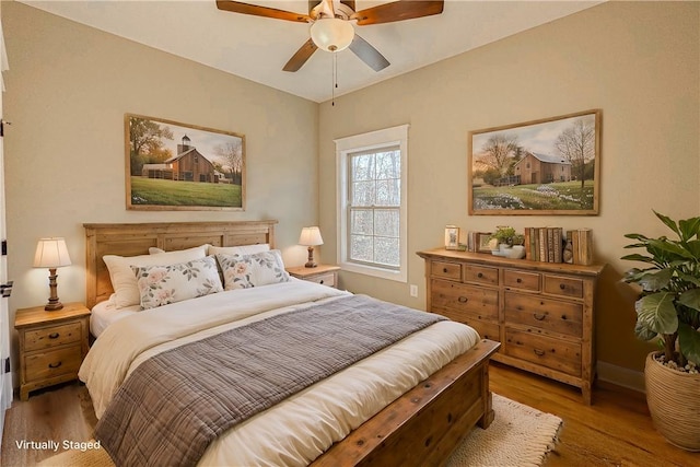 bedroom with hardwood / wood-style floors and ceiling fan