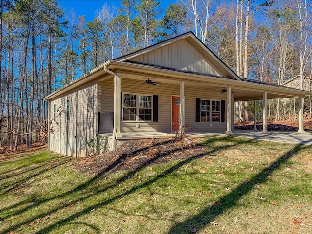 view of front of house with a carport, ceiling fan, a porch, and a front lawn