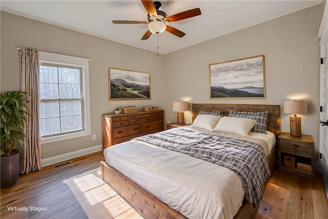 bedroom with ceiling fan and light wood-type flooring