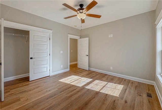 unfurnished bedroom with ceiling fan, a closet, and light hardwood / wood-style flooring