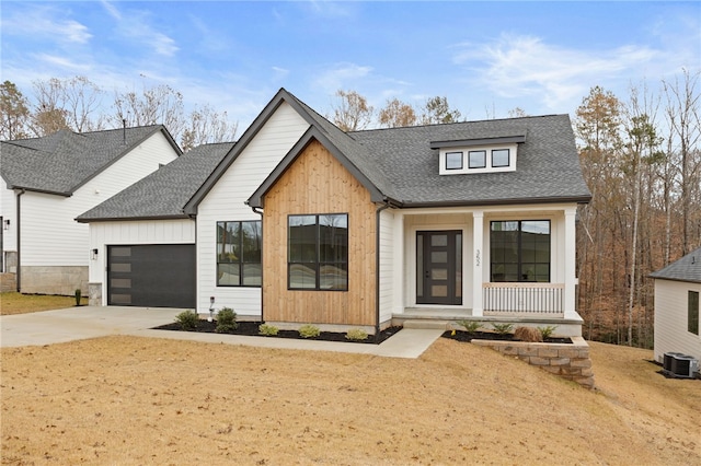 modern inspired farmhouse with a porch, central AC, and a garage