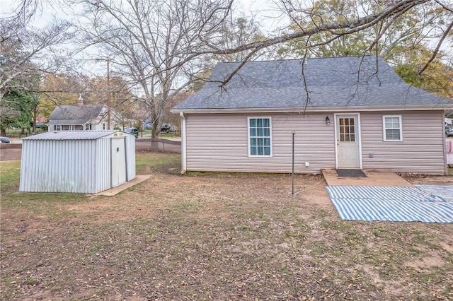 rear view of house with a storage unit