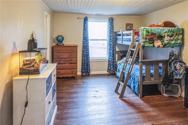 bedroom with dark hardwood / wood-style floors