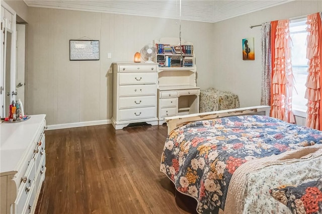 bedroom with dark hardwood / wood-style flooring and ornamental molding