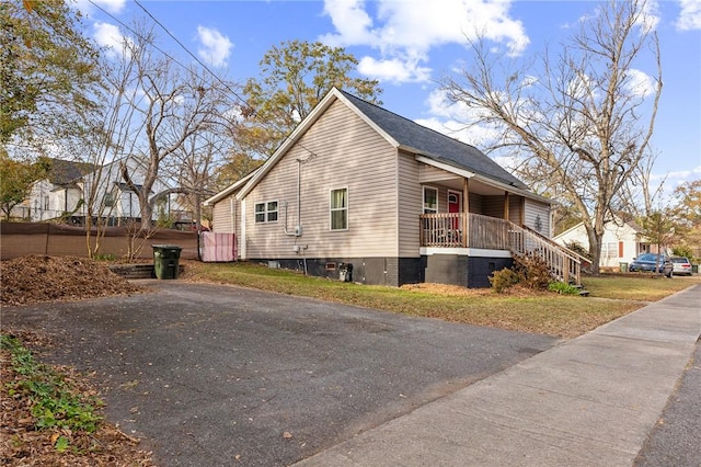 view of property exterior featuring covered porch