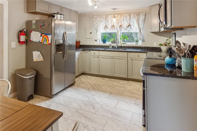 kitchen featuring pendant lighting, sink, appliances with stainless steel finishes, and dark stone counters