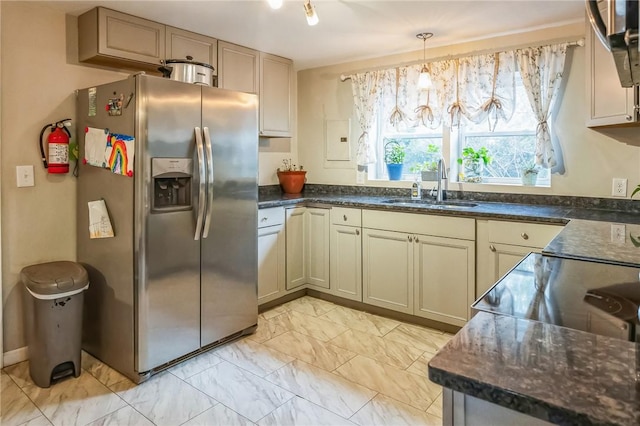 kitchen with hanging light fixtures, sink, and stainless steel appliances