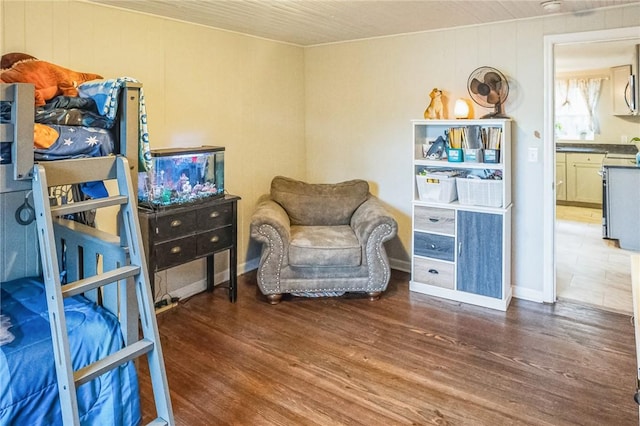 living area with wood walls and wood-type flooring