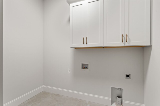 clothes washing area featuring washer hookup, electric dryer hookup, and cabinets