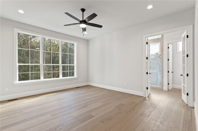 unfurnished room featuring ceiling fan and light hardwood / wood-style floors