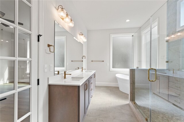 bathroom with vanity and independent shower and bath