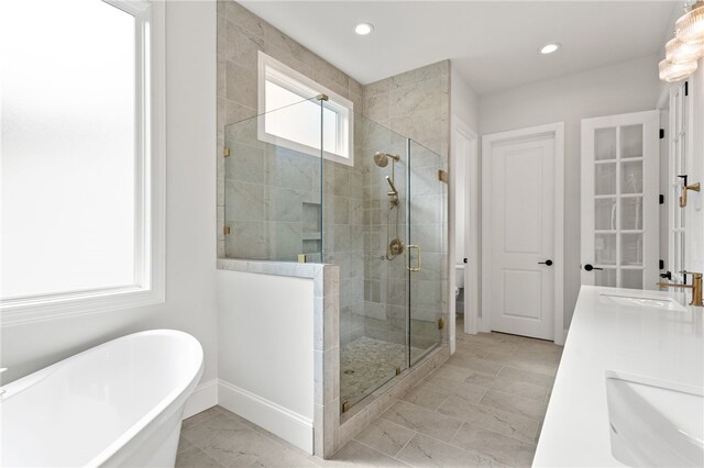 bathroom with vanity and separate shower and tub