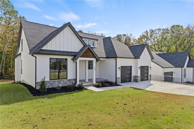 modern farmhouse with a front lawn and a garage