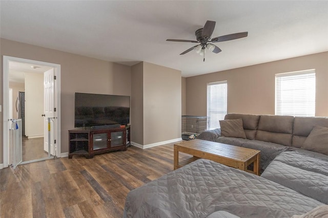 living room with dark hardwood / wood-style floors and ceiling fan