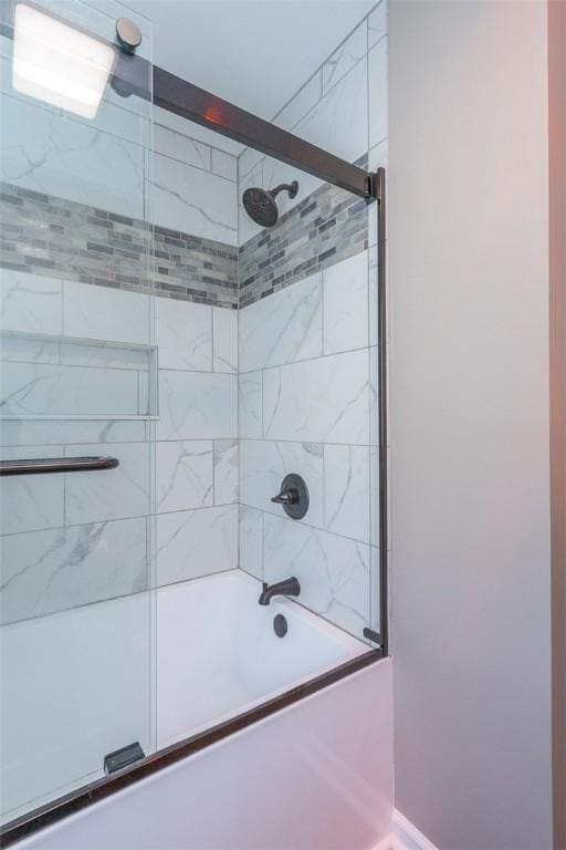 bathroom featuring shower / bath combination with glass door