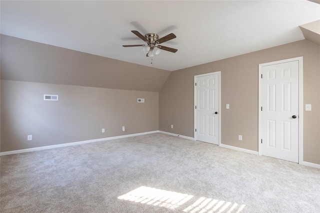 bonus room featuring ceiling fan, light colored carpet, and lofted ceiling