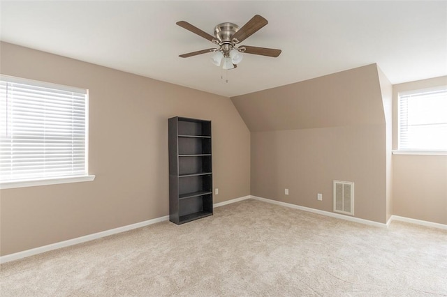 bonus room featuring ceiling fan, light colored carpet, and vaulted ceiling