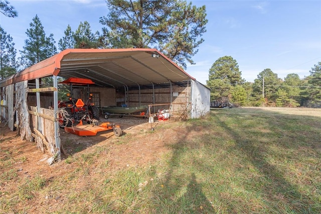 view of outdoor structure featuring a carport and a yard